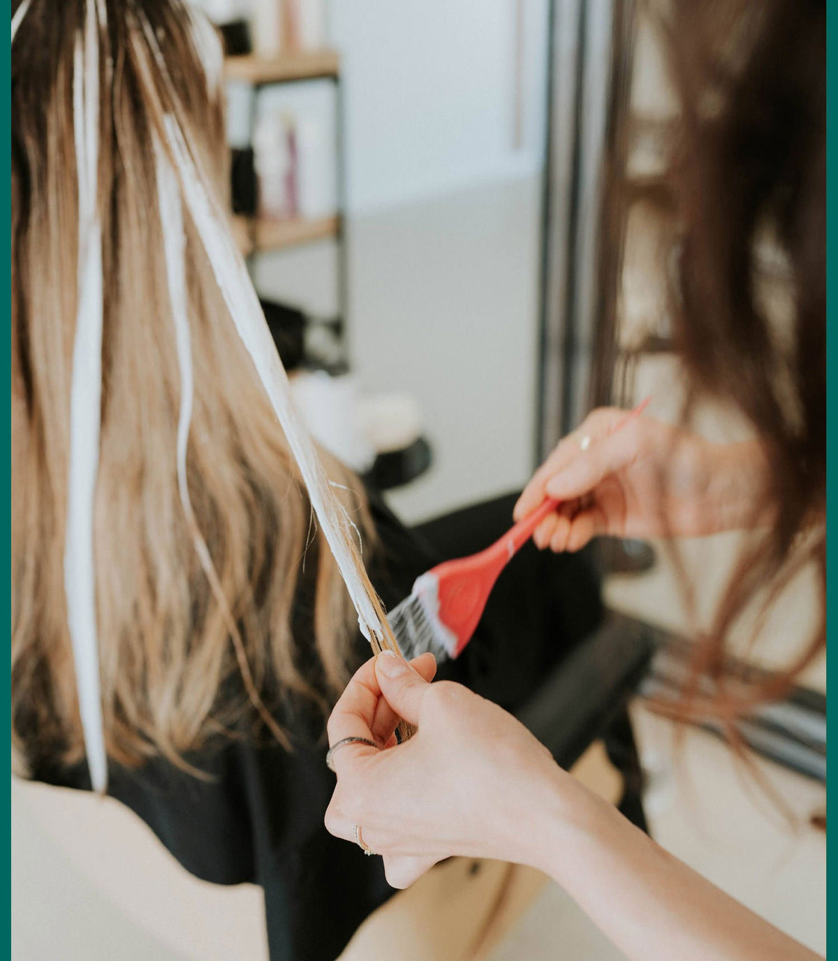 Stylist painting balayage highlights onto a client's hair at Zayda Hair & Apothecary, San Antonio TX
